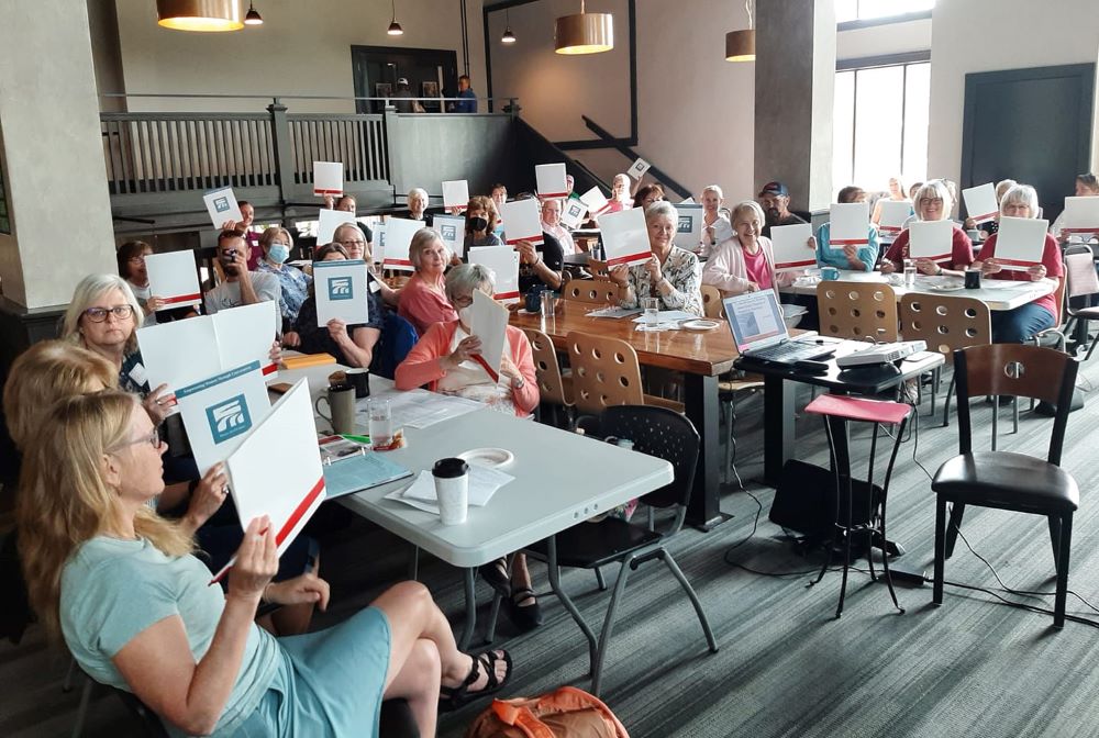 A group of women attending an indoor listening session.