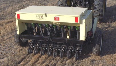 photo of native grass drill pulled behind a tractor