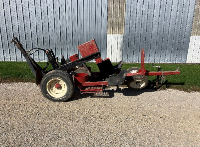 Photo of a tree planter that connects to a tractor